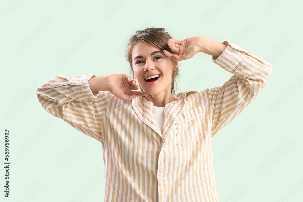 Awaken young woman stretching on green background Awaken young woman stretching on green background