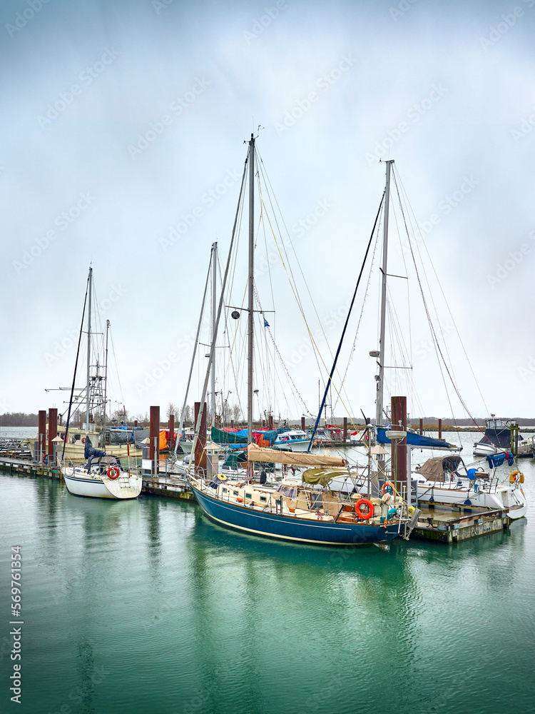 Fishing boats and sailboats in Steveston harbor. Waterfront Steveston Fisherman's Wharf. Richmond, BC, Canada
