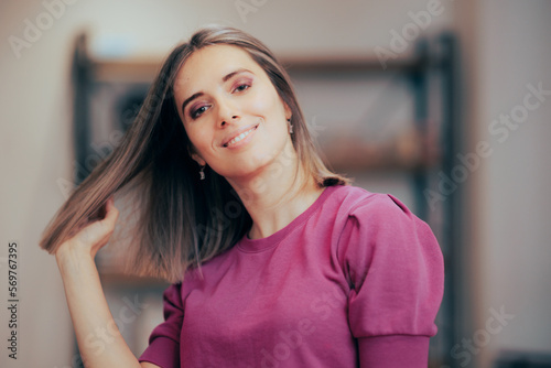 Beautiful Woman Showing Off Her New Haircut and Hair Color. Pretty lady presenting her hair in motion enjoying new look
 photo