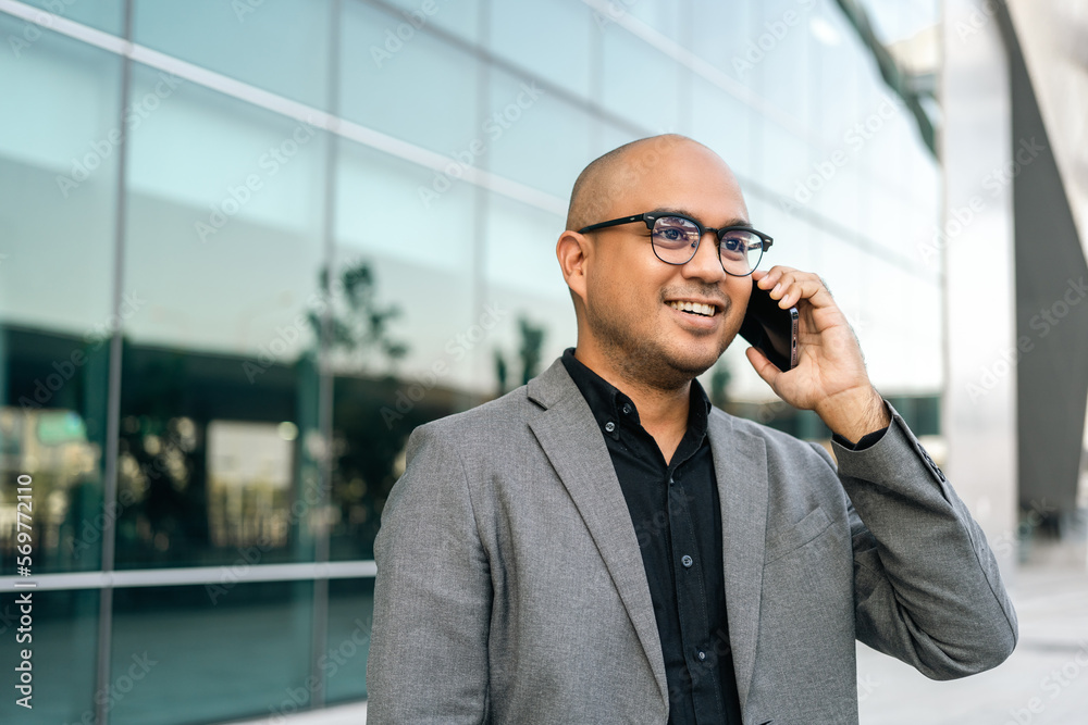 Senior manager business man in suit with cell phone at the buildings downtown. Confident man using smartphone looking towards their goals for success. Executive business man