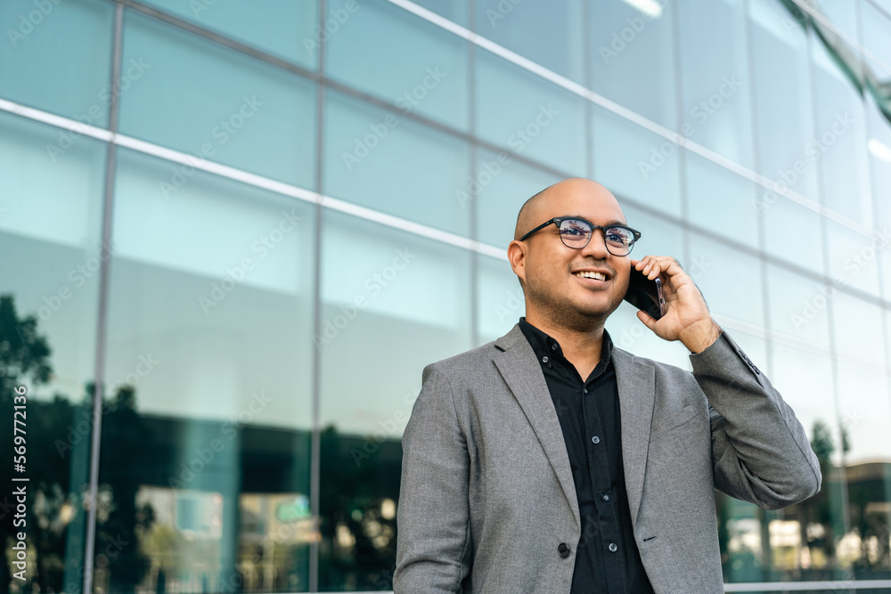 Senior manager business man in suit with cell phone at the buildings downtown. Confident man using smartphone looking towards their goals for success. Executive business man