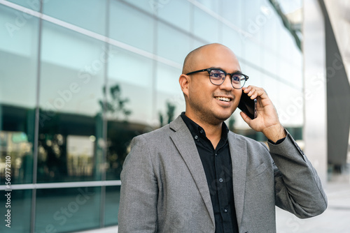 Senior manager business man in suit with cell phone at the buildings downtown. Confident man using smartphone looking towards their goals for success. Executive business man