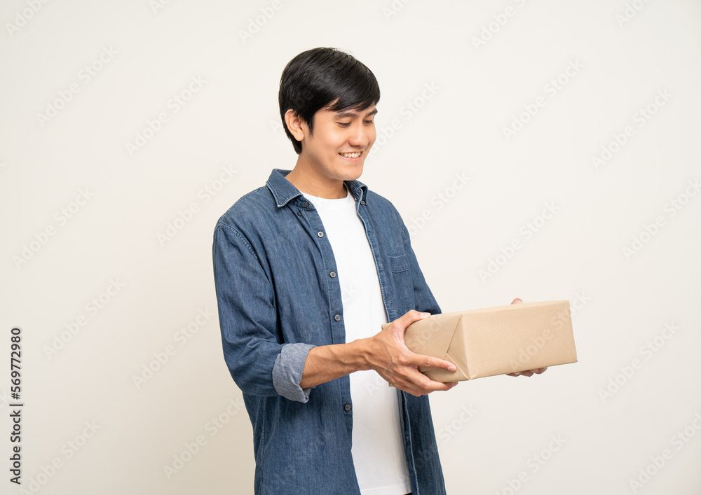 Young excited asian man with many parcel cardboard standing on isolated white background. Cheerful male holding lot of parcel box receive from the delivery service Young excited asian man with many parcel cardboard standing on isolated white background. Cheerful male holding lot of parcel box receive from the delivery service