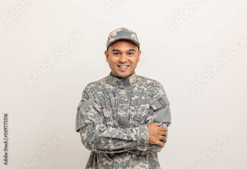Asian man special forces soldier standing with arms crossed against on the field Mission. Commander Army soldier military defender of the nation in uniform standing on white background.