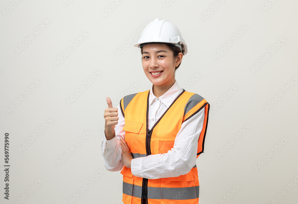 Asian engineer worker woman or architect with white safety helmet standing on isolated white background. Mechanic service factory Professional work job occupation in uniform showing thumbs up. Asian engineer worker woman or architect with white safety helmet standing on isolated white background. Mechanic service factory Professional work job occupation in uniform showing thumbs up.