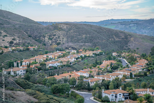 View of a residential area on a slope from a hiking trail at San Clemente, California. Subdivision on a mountain with a view of sky at the background.