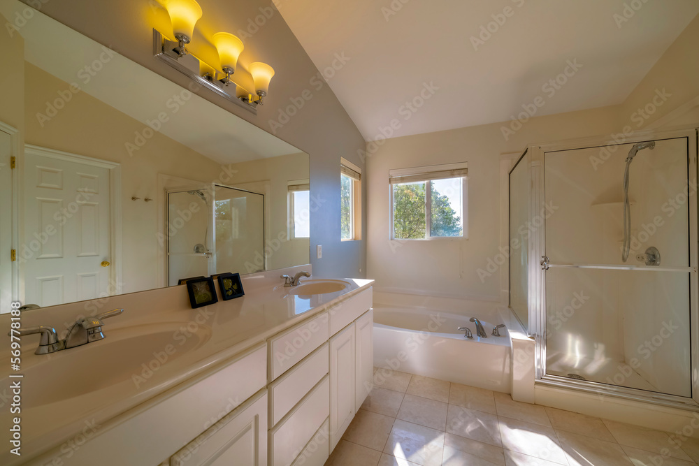 Utah Master bathroom interior with double vanity sink, windows, tub