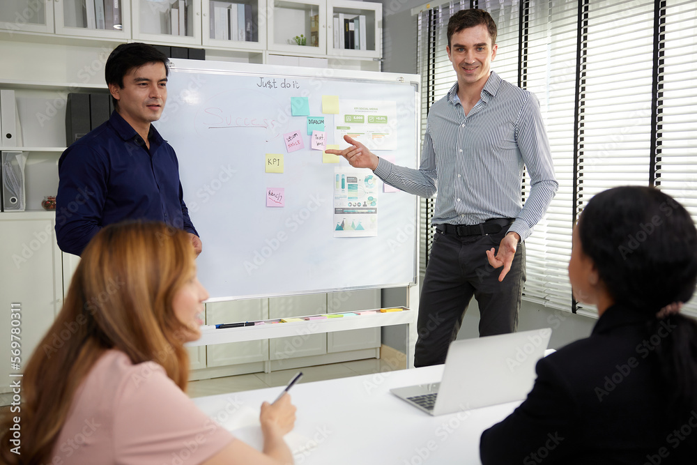 businesspeople team meeting or seminar. and presentation about work project on whiteboard businesspeople team meeting or seminar. and presentation about work project on whiteboard