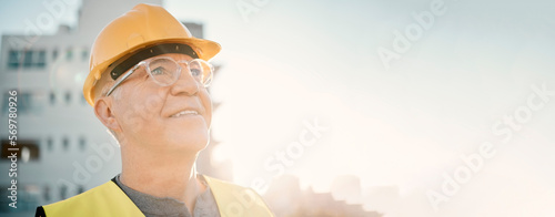 Senior man, builder and construction in the city with smile and helmet for safety or security at site on mockup. Elderly male contractor, engineer or technician face smiling with hard hat in town