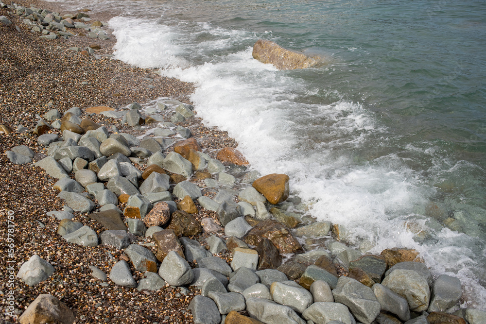 foamy coastal sea wave of a pebble beach foamy coastal sea wave of a pebble beach