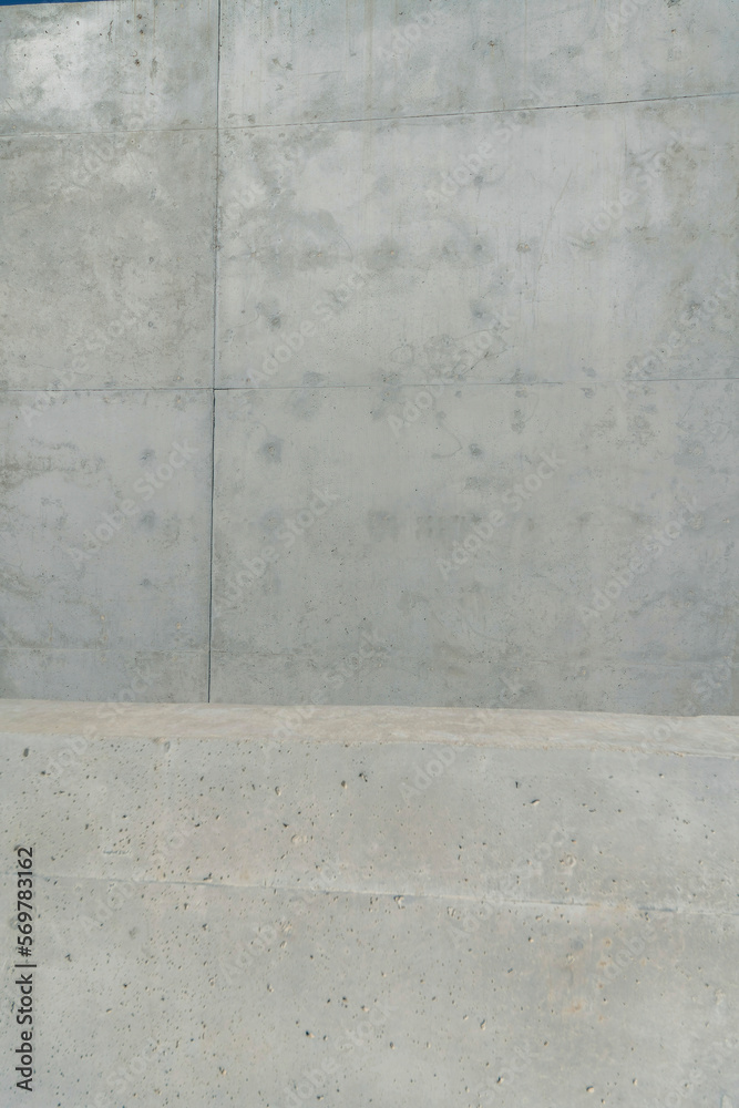 Concrete slab close-up of a building wall at Waterloo Park in Austin, Texas. Gray concrete building wall close-up in a vertical shot view. Concrete slab close-up of a building wall at Waterloo Park in Austin, Texas. Gray concrete building wall close-up in a vertical shot view.