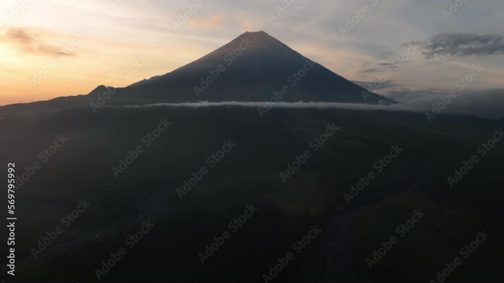 Aerial Lockdown Shot Of Clouds Moving By Volcanic Mountain During Sunset - Java, Indonesia Aerial Lockdown Shot Of Clouds Moving By Volcanic Mountain During Sunset - Java, Indonesia
