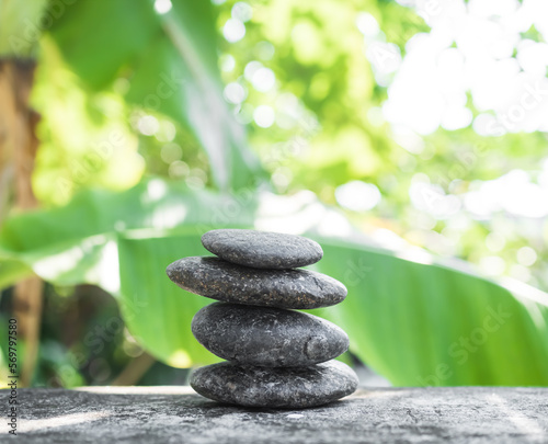 Stack Stone on Blur Plant Growth Tree wit Bokeh Background Texture Circle Pebbles Pyramid on Wood Nature Concept for Health spa Aromatherapy Meditation Natural Calm Buddhism.
