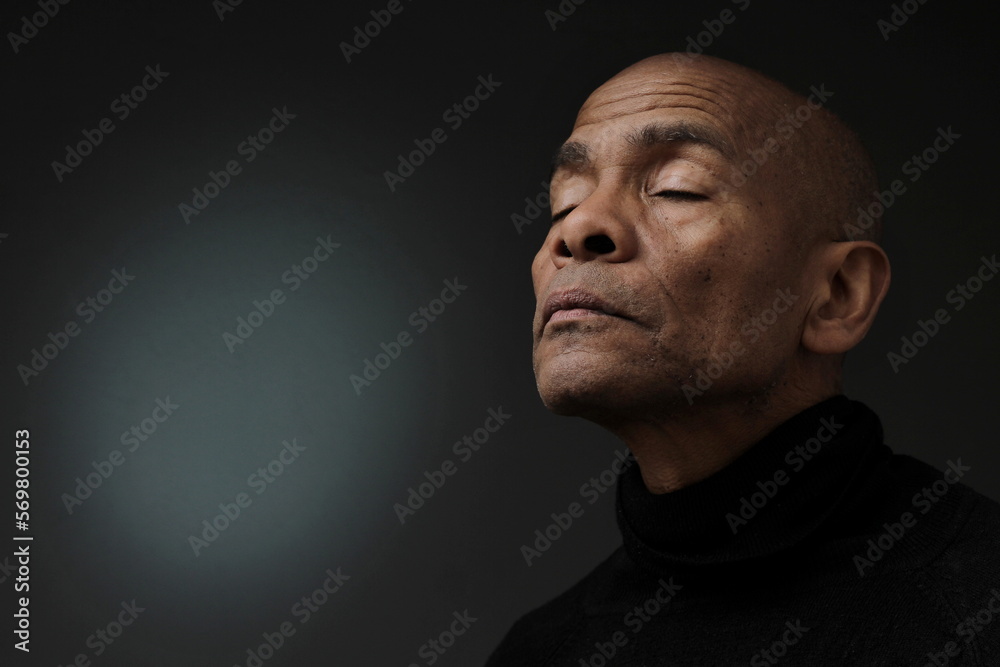 man praying to god with grey black background with people stock photo man praying to god with grey black background with people stock photo
