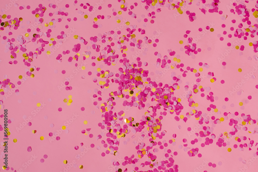 Pink abstract confetti background with lots of falling circles. Festive decorative element of tinsel for design