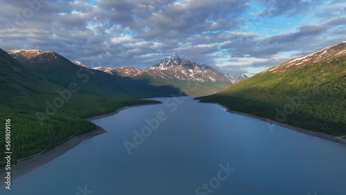 Eklutna Lake With Snowcapped Mountains And Cloudy Sky In Anchorage, Alaska - aerial drone shot photo