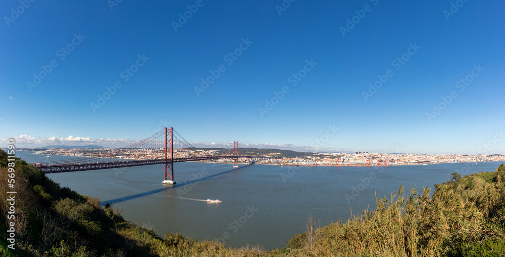 Panoramic landscape of the April 25 bridge over the Tagus river and the Lisbon city in the background Panoramic landscape of the April 25 bridge over the Tagus river and the Lisbon city in the background