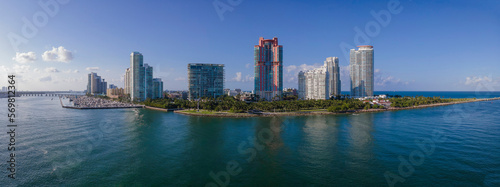 Buildings overlooking a water channel against blue sky on a sunny day. Government Cut is a manmade shipping channel between Miami Beach and Fisher Island