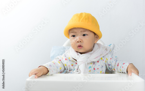 asian baby sitting in high chair white background,baby in home,thailand baby