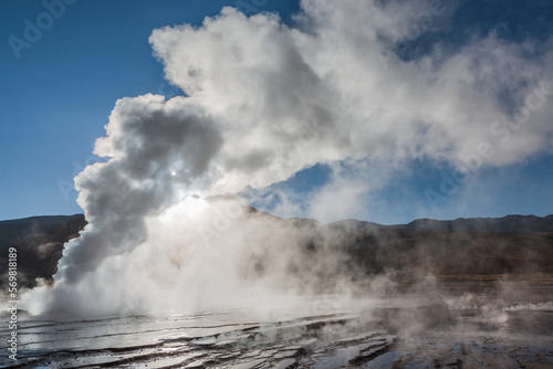 Steaming vent on the El Tatio geyser field in the high Andes of northern Chile backlit by the sun