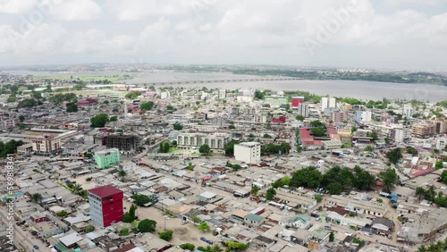 Sunset over city in Africa. Abidjan, Ivory Coast, Africa, Treichville, drone aerial view

 photo