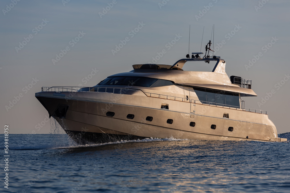 luxury motoryacht sailing at sunset