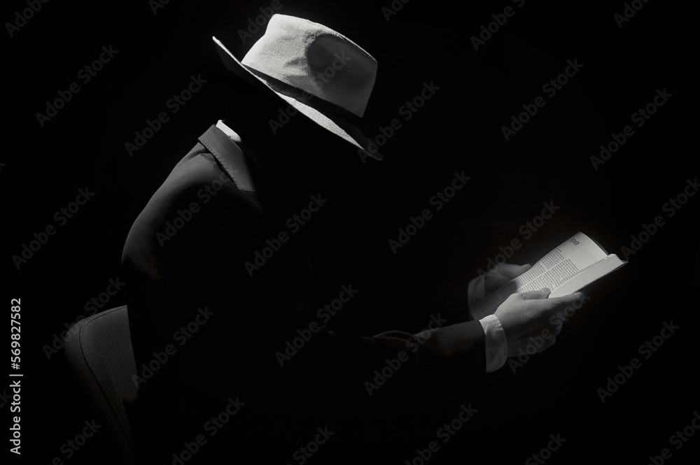 Faceless Man Wearing Hat and Reading Bible