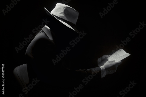 Faceless Man Wearing Hat and Reading Bible