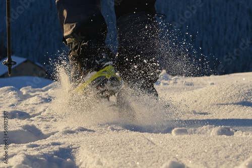 Man Walking On Snow With Shoe Spikes