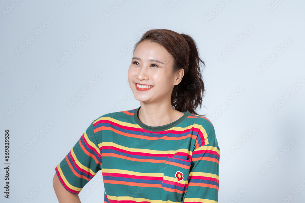 Cute asian girl showing white healthy smile, grinning, standing over white background Cute asian girl showing white healthy smile, grinning, standing over white background