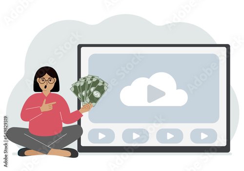 A woman holds paper banknotes in his hand, next to a computer with a video. Freelancer, earning money, working on the Internet, training, coaching, business, remote work. photo