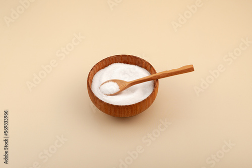 Isomalt or Isomaltitol  powder in wooden bowl. Food additive E963, sweetener. Isomalt, sugar substitute, a type of sugar alcohol. Confectionery ingredient photo