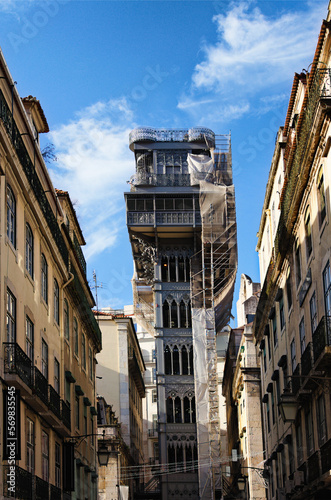 Scenic cityscape view of ancient part of the Lisbon city. Old Santa Justa Lift between vintage colorful buildings. Architectural icon of the city of Lisbon. Travel and tourism concept