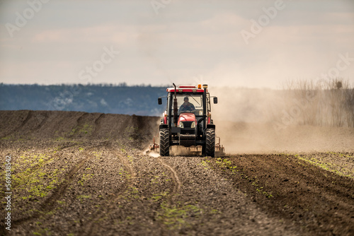 The promise of spring, tractor readying the fields for a new season of growth photo