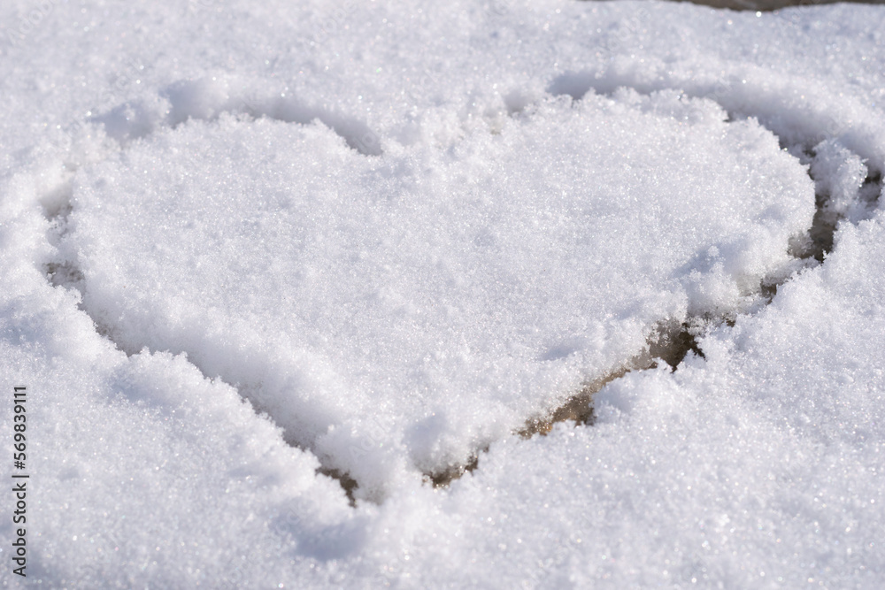 Heart outlined on snow, symbol of love, snow background Heart outlined on snow, symbol of love, snow background