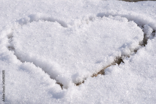 Heart outlined on snow, symbol of love, snow background © Ludmila