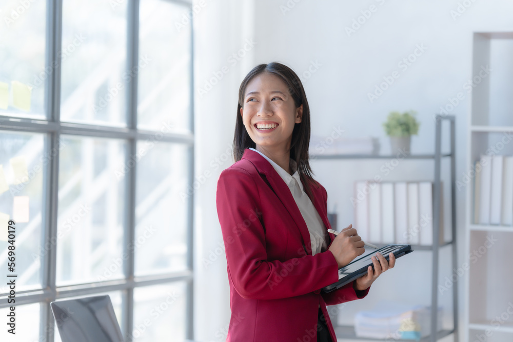 Young pretty attractive asia chinese half thai woman mixed race working with online balance sheet, online bookkeepers helpful consult accounting reports and financial statements. using tablet pc Young pretty attractive asia chinese half thai woman mixed race working with online balance sheet, online bookkeepers helpful consult accounting reports and financial statements. using tablet pc