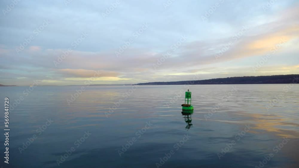 Dolly shot of metallic buoy in sea against cloudy sky during sunset Dolly shot of metallic buoy in sea against cloudy sky during sunset