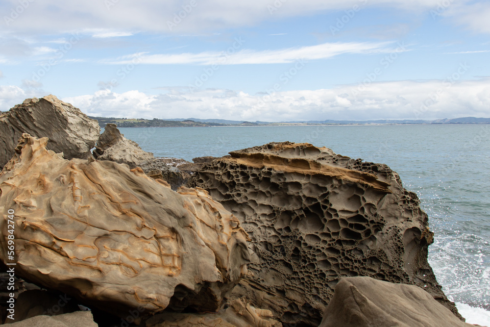 Coastline with big rocks and blue sea on background, Auckland, New Zealand. Coastline with big rocks and blue sea on background, Auckland, New Zealand.