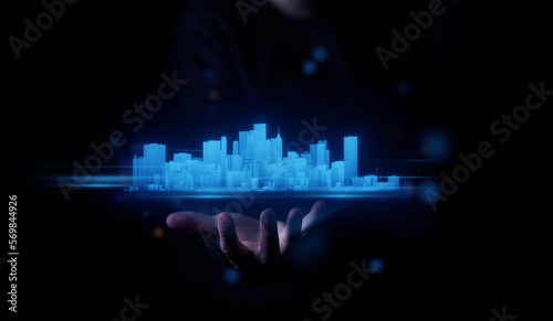 concept of metaverse technology man hand holding hologram cyber digital data city landscape real estate building background. meta city landscape cyberspace. metaverse concept                         