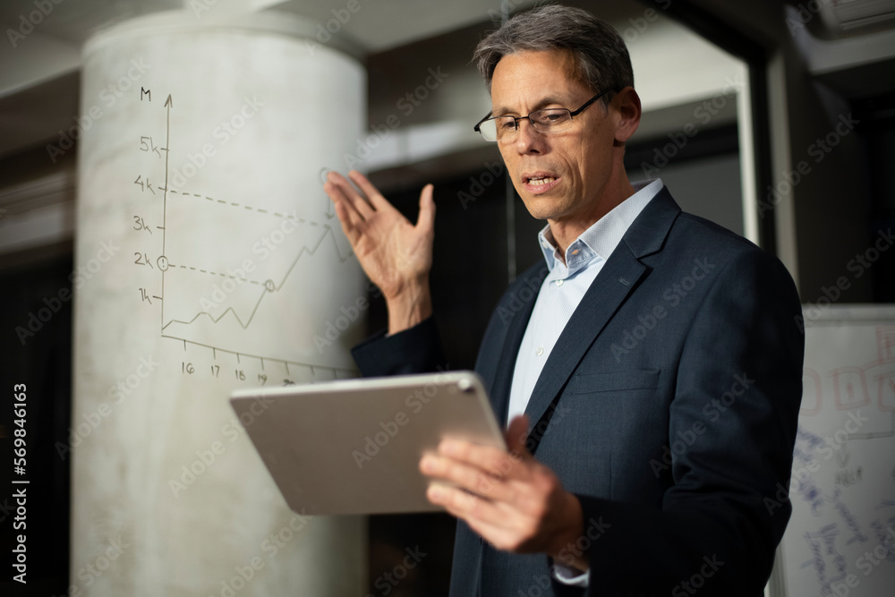 Portrait of businessman in office. Man using digital tablet. Businessman having video call Portrait of businessman in office. Man using digital tablet. Businessman having video call