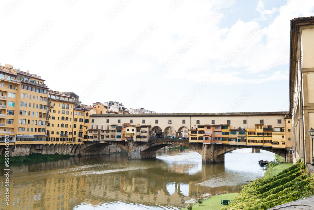 colored houses on a bridge in the middle of Florence