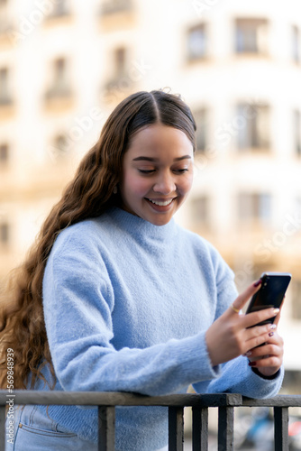 young girl using her smartphone in the city