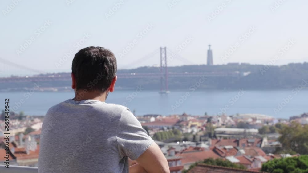 A young man looks at the bridge on April 25 in the Portuguese city of Lisbon. A young man looks at the bridge on April 25 in the Portuguese city of Lisbon.