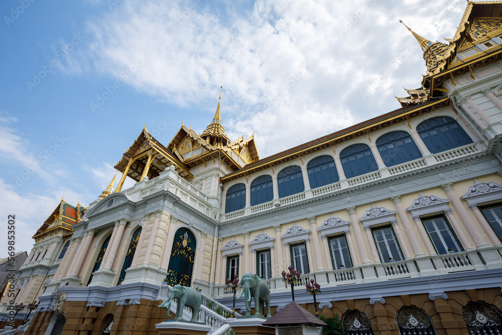Temples and tourists at Bangkok's Grand Palace. The Grand Palace is made up of various buildings, halls and pavilions
