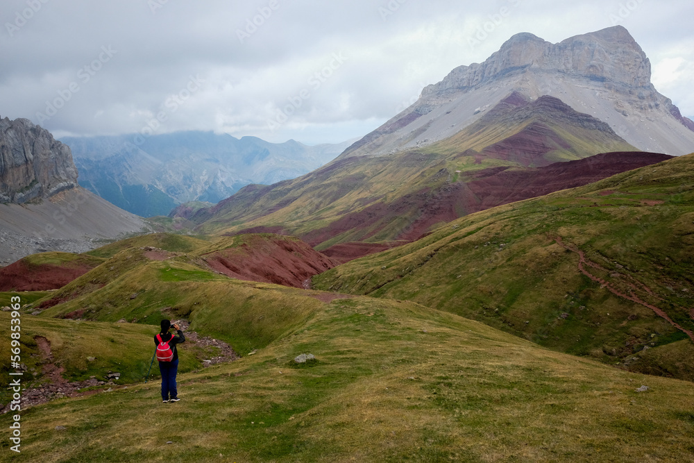 Lonely woman walking in the immensity of nature of the Spanish Pyrenees.