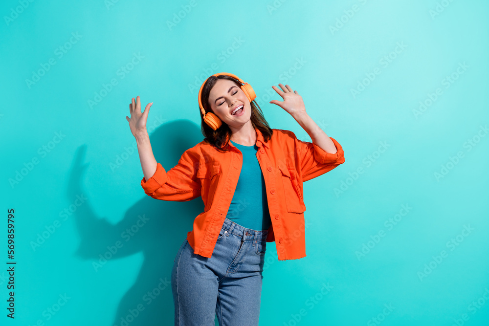 Photo of joyful positive lady eyes closed wear stylish orange clothes good mood have fun isolated on aquamarine color background