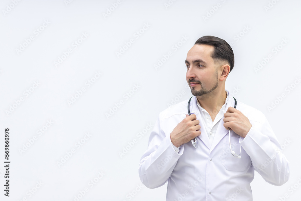 Photo of male mature doctor posing at camera with a stethoscope. Photo of male mature doctor posing at camera with a stethoscope.