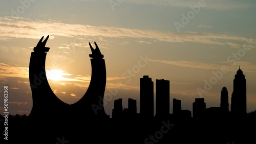 The crescent tower in the newly developing city Lusail in Qatar. Time Lapse at Sunrise with Colorful Clouds