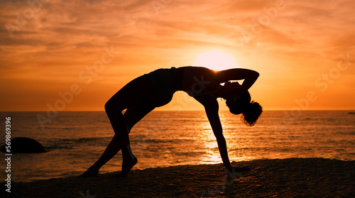 Balance  yoga and silhouette of woman on beach at sunrise for exercise  training and pilates workout. Fitness  meditation and shadow of girl by ocean for sports  wellness and stretching in morning